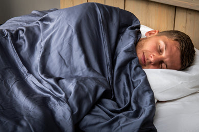 man met verzwaringsdeken op bed