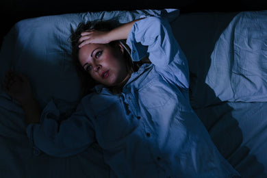 vrouw ligt wakker op bed