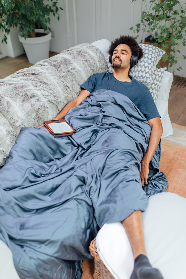 Novaline weighted blanket with bamboo cover blue man sleeps on couch